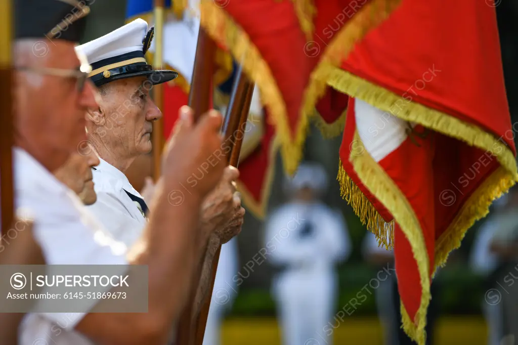 Participants display flags during a Victory in Europe Day” World War II remembrance ceremony outside the Haut-commissariat de la République Tahiti, French Polynesia, May 8, 2022. Through exercises and engagements, we improve our ability to work together with our allies and partners and build on our collective strengths.