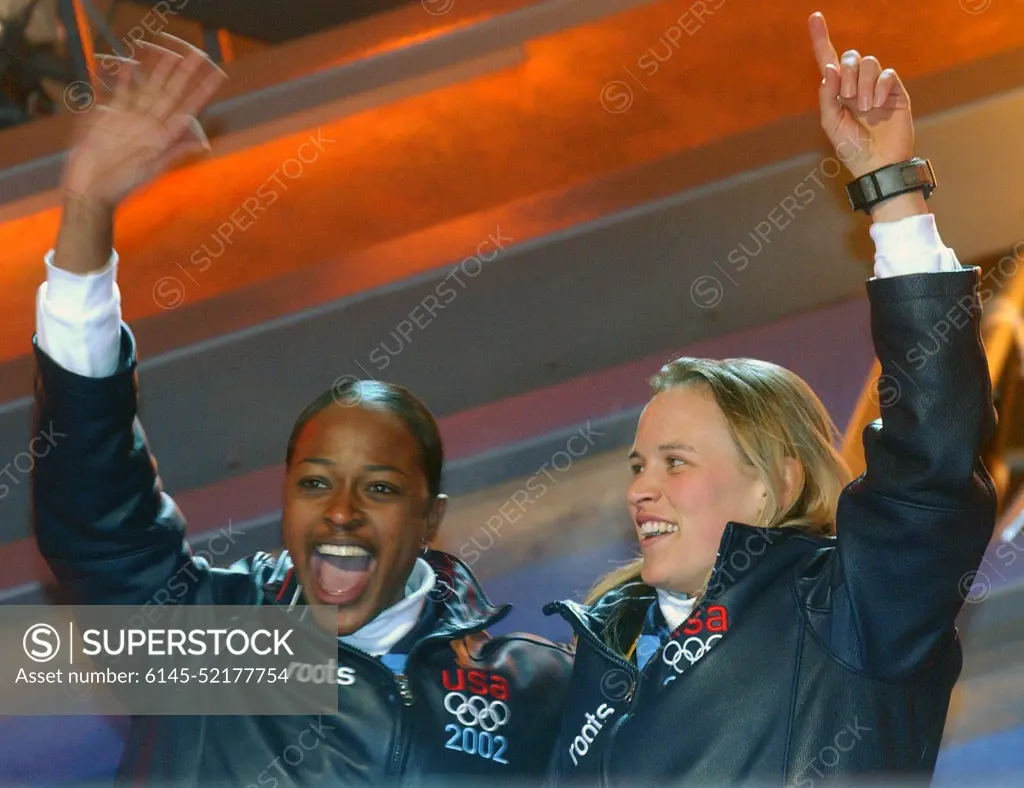 Vonetta Flowers, left, and World Class Athlete SPECIALIST Jill Bakken, USA, react to the crowd as they step up to the podium during the medal ceremony in Salt Lake City, after winning the gold medal in women's two-man bobsled for the United States in the 2002 WINTER OLYMPIC GAMES. The team was not favored going in but ended up breaking a 46 year drought for the United States, winning the Gold over another American team and favored German team, setting a track record in the process. Subject Operation/Series: 2002 WINTER OLYMPIC GAMES Base: Salt Lake City State: Utah (UT) Country: United States Of America (USA)