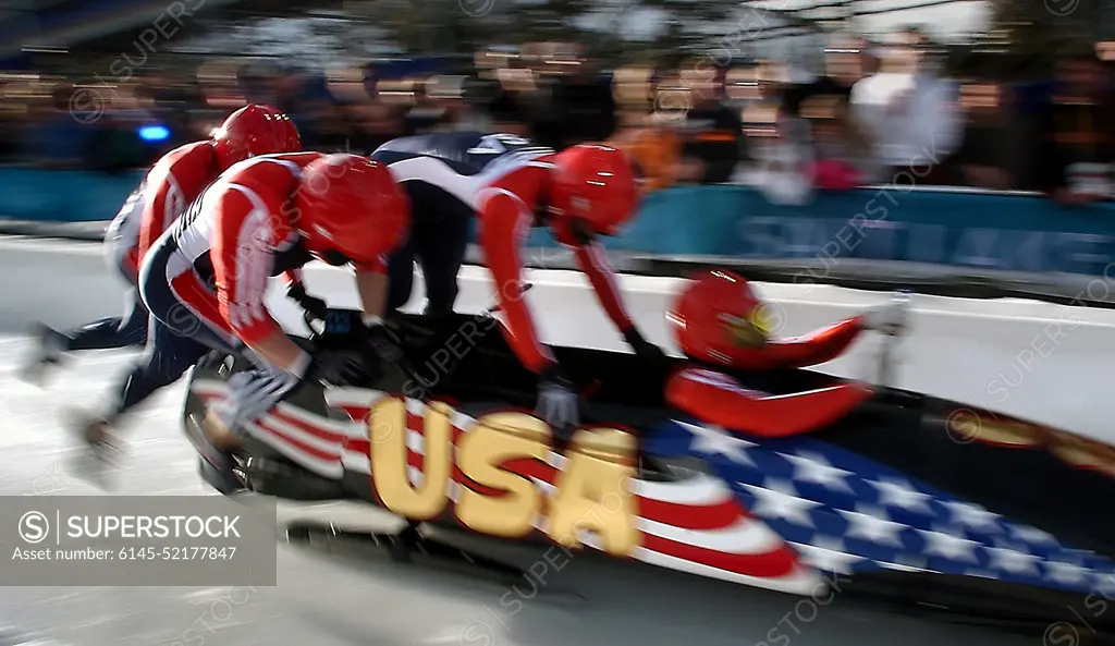 (Right to left) Pilot Brian Shimer, World Class Athletes SPECIALIST Mike Kohn, USA, and SPECIALIST Doug Sharp, USA, with brakeman Dan Steele sprint down the start at the Utah Olympic Park track in Park City, Utah, during their first run of the men's four-man bobsled in the 2002 WINTER OLYMPIC GAMES. Subject Operation/Series: 2002 WINTER OLYMPIC GAMES Base: Park City State: Utah (UT) Country: United States Of America (USA)