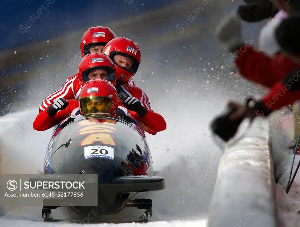 With snow and ice flying up behind them, driver Brian Shimer, World Class Athletes SPECIALIST Mike Kohn, USA, and SPECIALIST Doug Sharp, USA, and brakeman Dan Steele come to a stop. They just completed their third run for "USA-2" at the Utah Olympic Park track in Park City, Utah, during the 2002 WINTER OLYMPIC GAMES. They would surprisingly go on to win the bronze medal behind "USA-1" and "Germany-2.". Subject Operation/Series: 2002 WINTER OLYMPIC GAMES Base: Park City State: Utah (UT) Country: United States Of America (USA)