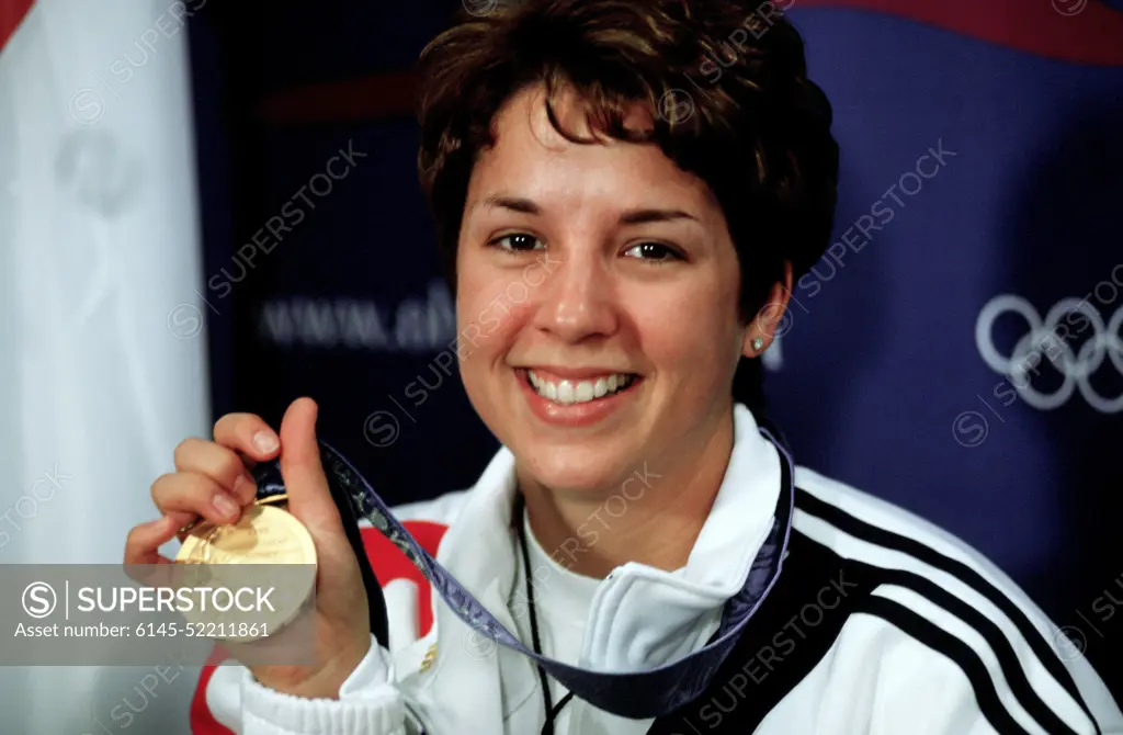 Nancy Johnson holds up the gold medal she won in the 10-Meter Air Rifle Competition at the 2000 Olympic games in Sydney, Australia, September 16th, 2000. Nancy is married to US Army STAFF Sergeant Ken Johnson (Not shown) who is also on the US shooting team. Base: Sydney State: New South Wales Country: Australia (AUS)