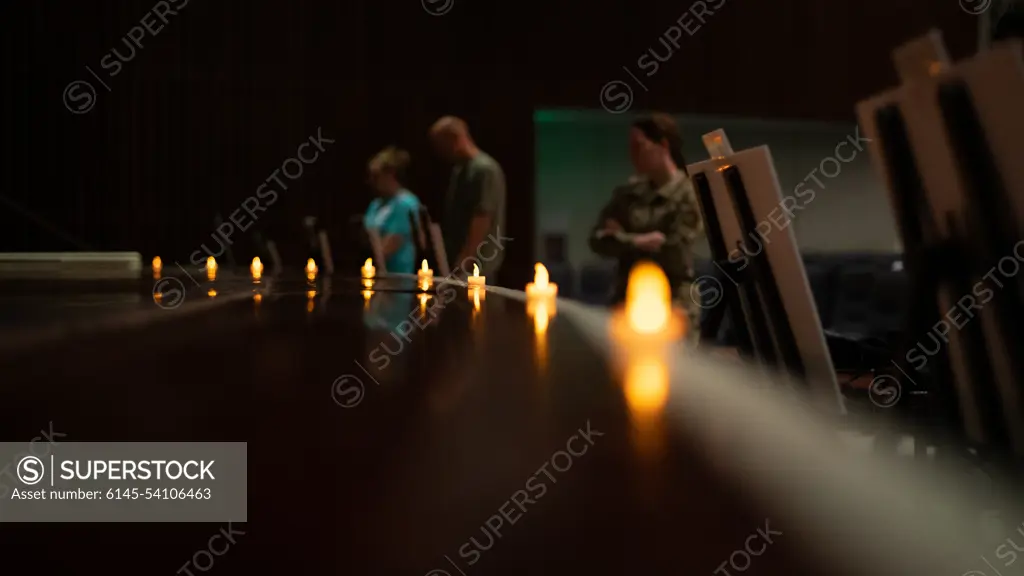 Attendees read posters about holocaust events during a candlelight ceremony in honor of the Days of Remembrance at Kadena Air Base, Japan, April 29, 2022. Historians estimate that nearly one-third of the worlds Jewish population, or six-million people, died as a result of the Holocaust.