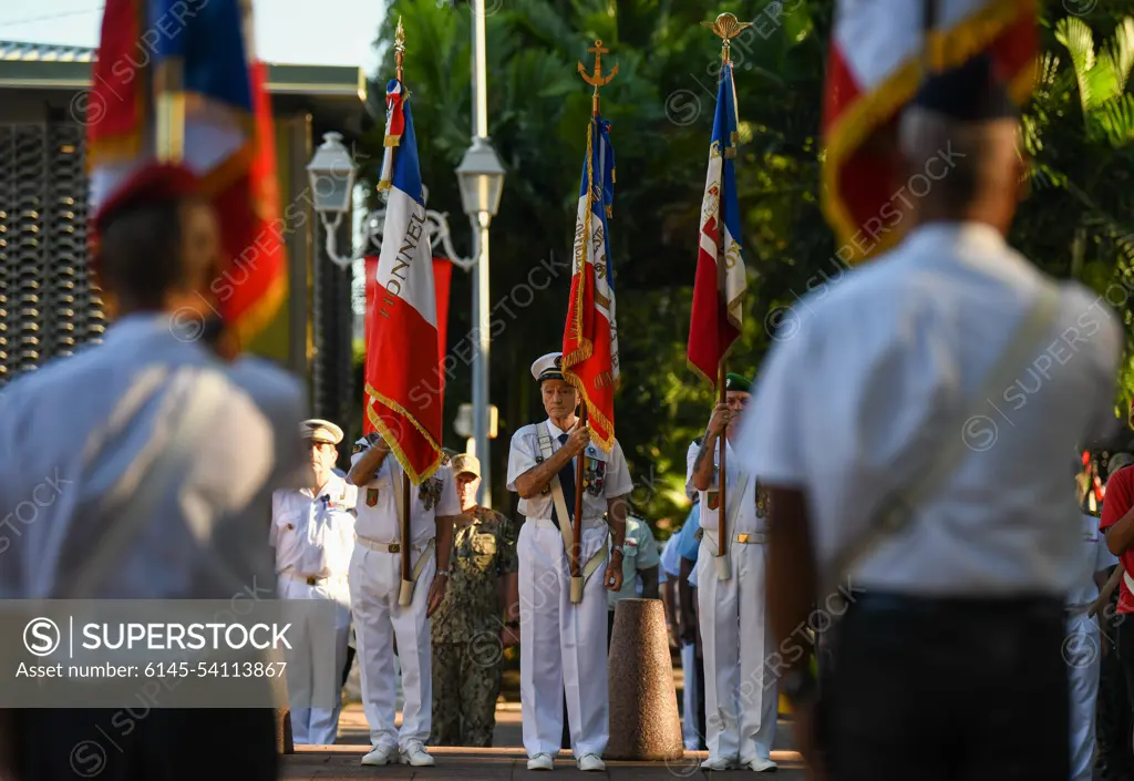 Participants hold flags in preparation for Victory in Europe Day a World War II remembrance ceremony outside the Haut-commissariat de la République Tahiti, French Polynesia, May 8, 2022. The ceremony kicks off Marara 22, a multinational training exercise which enhances combined interoperability between the U.S. military and Frances Combined Joint Task Force Headquarters in French Polynesia.