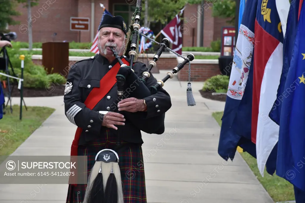 A bagpiper pipes the hymn "Amazing Grace" during the final moments of the Fort Bragg Soldier Recovery Unit Remembrance Ceremony in the shadow of Memorial Day.