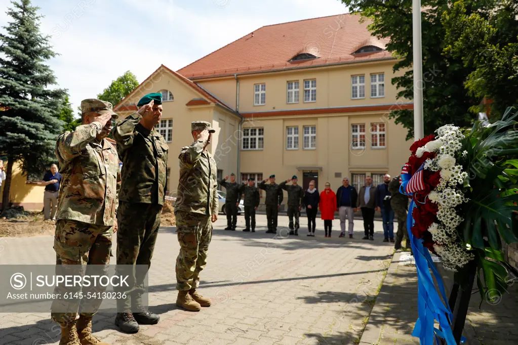 U.S. and Polish service members salute a wreath during a Memorial Day ceremony at Poznan, Poland, May 30, 2022. Memorial Day is a day of remembrance, dedicated to all those who gave their lives in service of the U.S.