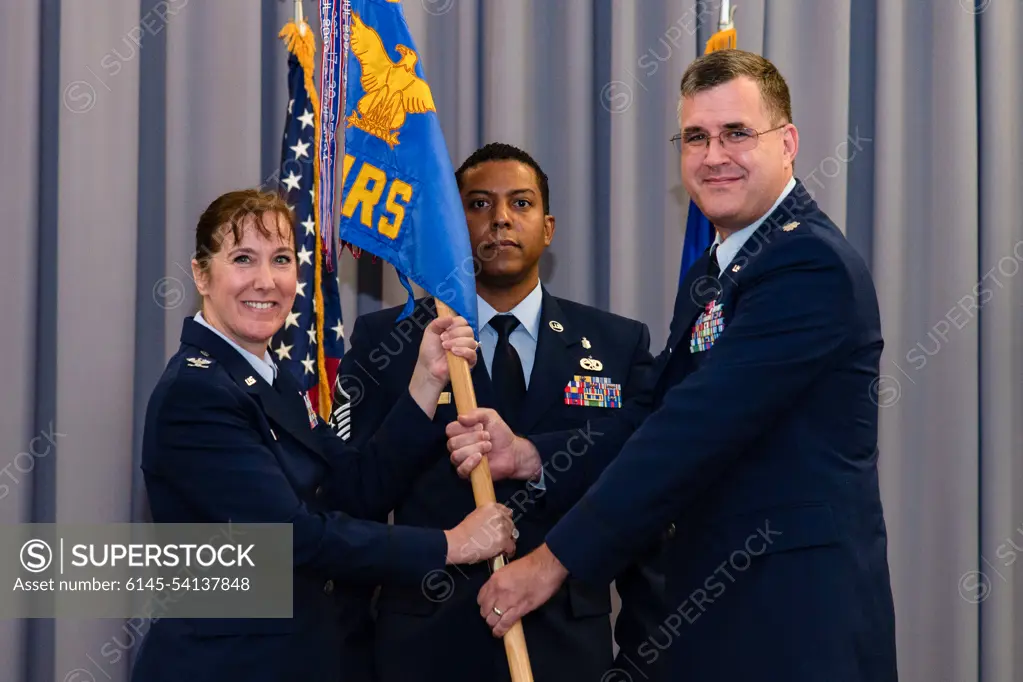 Lt. Col. John Batka, right, 436th Operational Medical Readiness Squadron commander, assumes command of the 436th OMRS after receiving the guidon from Col. Tracy Allen, left, 436th Medical Group commander, during a change of command ceremony held at The Landings on Dover Air Force Base, Delaware, June 9, 2022. The 436th OMRS Change of Command was the third of four ceremonies conducted within the 436th MDG. Guidon bearer for the ceremony was Master Sgt. Andrew Burgos, center, 436th OMRS superintendent.