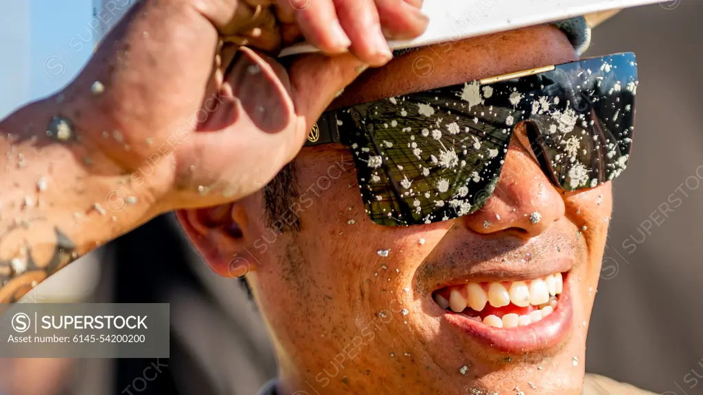 U.S. Air Force Tech. Sgt. Pookela Fernandez, assigned to the 154th Civil Engineering Squadron in the Hawaii Air National Guard pauses after concrete pour alongside members of the 163D Civil Engineering Squadron (CES) from March Air Reserve Base in California on the Special Olympics Training Facility construction grounds in Ewa Beach, Hawaii on August 3, 2022. The 163D CES participated in Innovative Readiness Training by traveling to the Island of Oahu to assist in the construction of a training facility, and connecting sidewalk for the impaired athletes of the Hawaii Special Olympics.