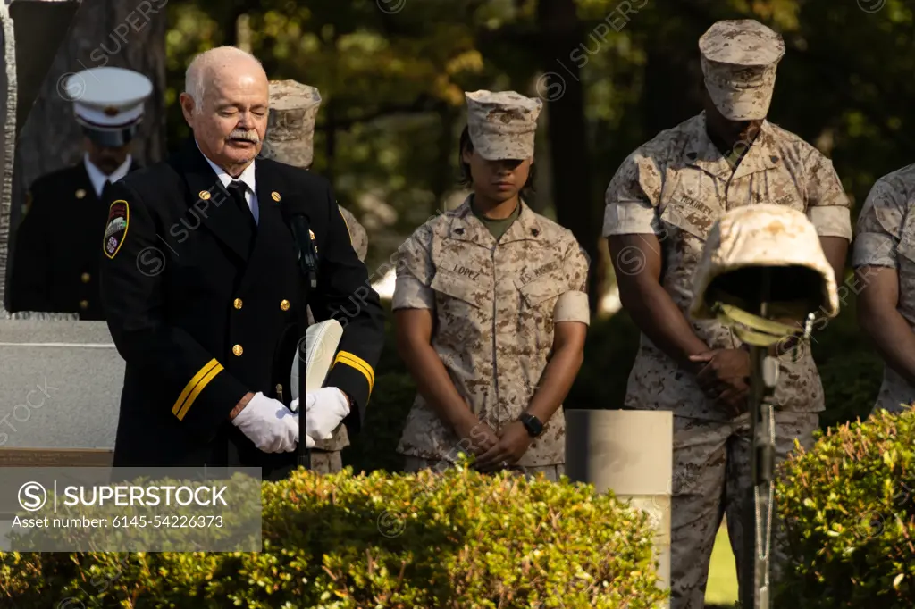 Retired Fire Captain Jeff Williams with the City of Jacksonville Fire Department, leads a prayer during the Patriot Day Observance Ceremony at Lejeune Memorial Gardens in Jacksonville, North Carolina, Sept. 9, 2022. The Patriot Day ceremony is held in remembrance of the Sept. 11 terrorist attacks and a tribute to those who made the ultimate sacrifice.