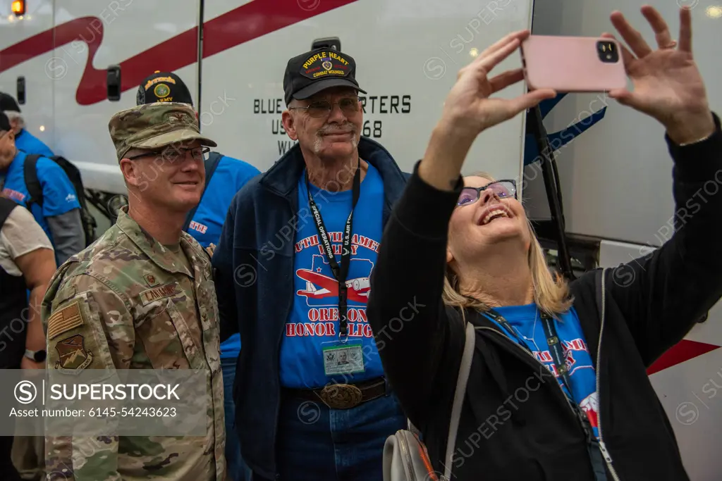 Col. Christopher Lantagne, 142nd Wing Vice Commander, poses for a photo with a Vietnam veteran, at Portland International Airport (PDX), September 30th, 2022, Portland, Ore. 142nd Wing leadership, along with members of the United States Coast Guard, were present to send off a group of 56 veterans departing to Washington D.C. as part of the Honor Flight Program. The Honor Flight Program was initiated in 2005, and provides roundtrip flights and chaperones to veterans wishing to visit various war memorials in Washington D.C.