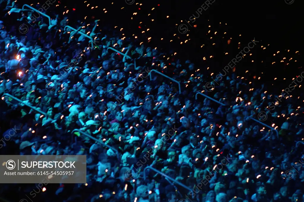 On September 15th, 2000, an audience of 110,000 inside Olympic Stadium bathes in blue light and become performers as they wave flashlights and blinking lights during the opening ceremonies for the Sydney 2000 Olympics. Base: Sydney State: New South Wales Country: Australia (AUS)