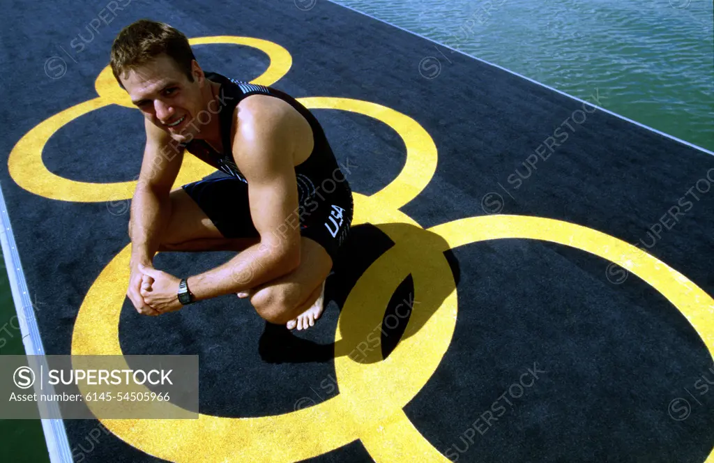 Olympian Henry Nuzum, a US Naval officer, poses on an Olympic Ring decorated pontoon September 15th, 2000 at the Regatta Centre, Penrith Lakes, Australia. Nuzum prepares for competition in the Men's Double Sculls to take place at the Sydney 2000 Olympics. Base: Penrith Lakes State: New South Wales Country: Australia (AUS)