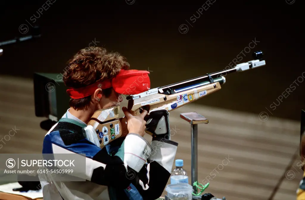 High angle, right rear view of Nancy Johnson as she takes aim for an Olympic gold medal during the Women's 10-meter Air Rifle Competition which she won, and claimed the first gold medal at the 2000 Olympic games in Sydney, Australia, September 16th, 2000. Nancy is married to US Army STAFF Sergeant Ken Johnson (Not shown) who is also on the US shooting team. He competes in the Men's 10-meter Air Rifle Competition. Base: Sydney State: New South Wales Country: Australia (AUS)