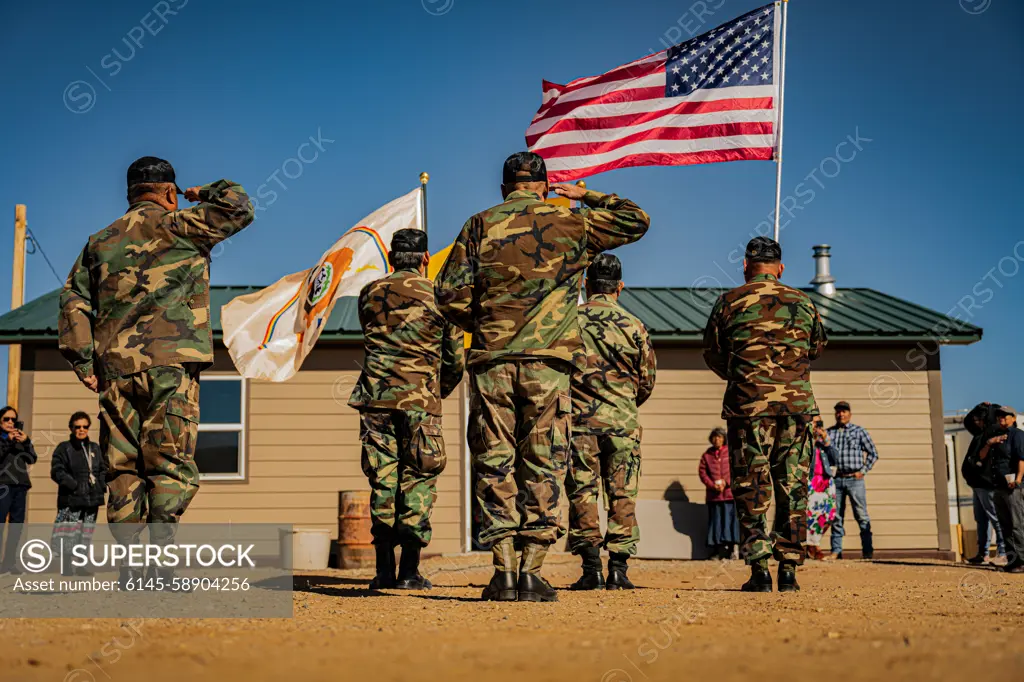 Members of the Shiprock Veterans Color Guard post the colors during a home-blessing ceremony for a Navajo Nation veteran in Shiprock, New Mexico, Feb. 28, 2024. Four Airmen representing the Indigenous Nations Equality Team attended the event to show support for their fellow Native American service members and veterans.  Air Force