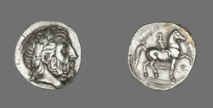 Tetradrachm (Coin) Depicting the God Zeus 348 BCE-336 BCE Pella. Coins were an excellent way for leaders to advertise their victories whether in battle or at the Olympic Games. King Philip (reigned 359ñ336 BCE), father of Alexander the Great, celebrated his win in the horse races at the Olympic Games by issuing this coin, complete with the victory palm in the jockeyís hand.. Silver . Ancient Greek