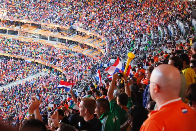 Dutch and Danish fans cheer during the Netherlands vs. Denmark World Cup soccer match at Soccer City Stadium in Johannesburg, South Africa, on June 14, 2010.