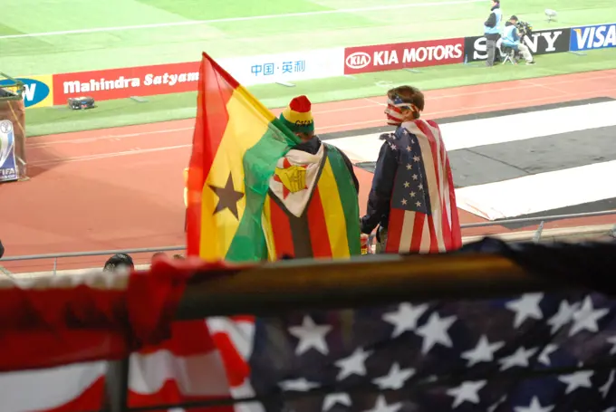 Ghanaian and American fans cheer for their respective teams during the FIFA 2010 World Cup soccer match between the United States and Ghana on June 26, 2010, at the Royal Bafokeng stadium in Rustenburg, South Africa.