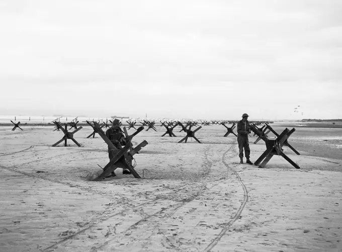 Operation Overlord (the Normandy Landings)- D-day 6 June 1944 The British 2nd Army: Royal Navy Commandos at La Riviere preparing to demolish two of the many beach obstacles designed to hinder the advance of an invading army.