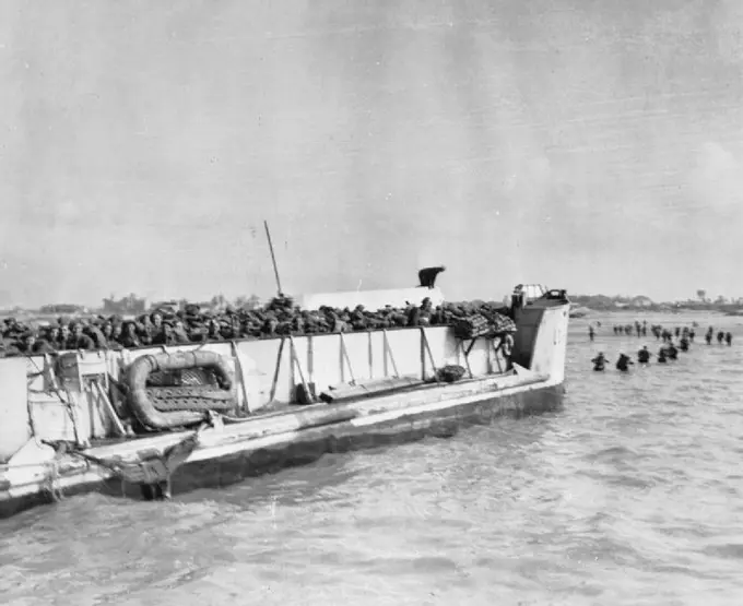 The Allied Invasion of Normandy, D-day, 6 June 1944 Troops disembark from a LCT (Landing craft (Tank)) and begin wading to the shore during the D-Day landings.