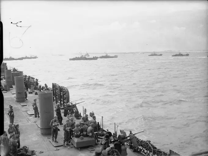 D-day - Allied Forces during the Invasion of Normandy 6 June 1944 British troops and US sailors manning 20mm gun positions on board USS LST-25 watch LCI(L) landing craft head towards the beaches of Gold assault area, 6 June 1944.