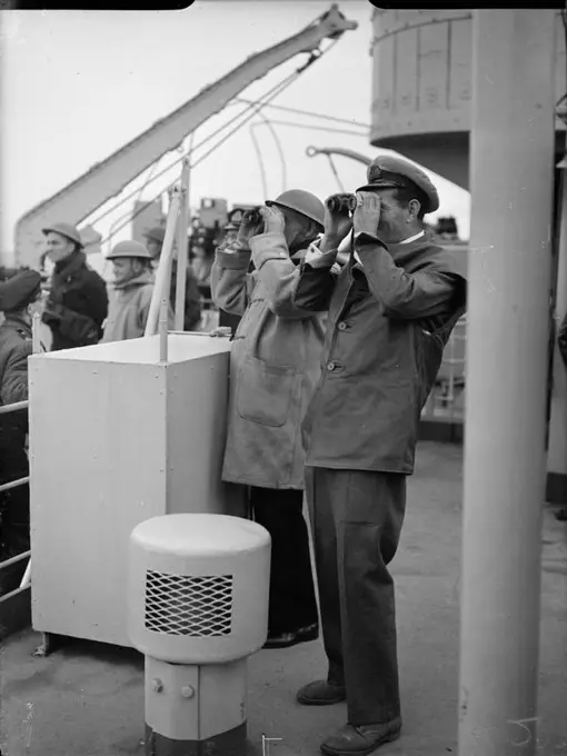 D-day - British Forces during the Invasion of Normandy 6 June 1944 Captain Sir Harold Campbell RN and Commander A Kimmins RN watch the progress of the landing of 50th Division from HMS BULOLO, headquarters ship of Assault Force G, 6 June 1944.