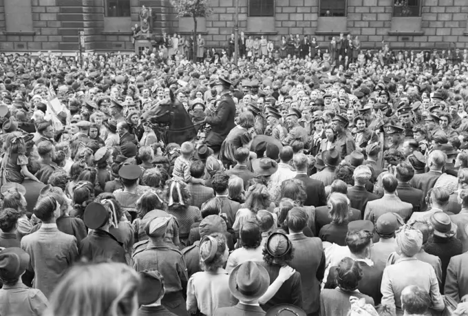 Ve Day Celebrations in London, England, UK, 8 May 1945 A mounted policeman moves through crowds of people gathered in Whitehall, London, to hear Churchill's Victory speech and to celebrate Victory in Europe Day, 8 May 1945.