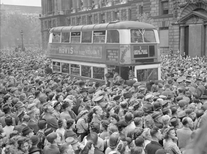 Ve Day Celebrations in London, England, UK, 8 May 1945 A number 3 double-decker bus slowly pushes its way through the huge crowds gathered in Whitehall to hear Churchill's Victory speech and celebrate Victory in Europe Day. The crowd is a mix of service personnel, civilians and children. Behind the bus, people line the balconies of the buildings along the street, and in the background, Westminster Abbey can be seen. :         8  1945