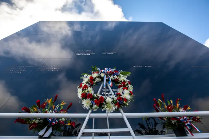 A wreath is placed in front of the Space Mirror Memorial at NASAs Kennedy Space Center Visitor Complex during the NASA Day of Remembrance on Jan. 27, 2022. Kennedy Space Center in Florida paid tribute to the crews of Apollo 1 and space shuttles Challenger and Columbia, as well as other astronauts who lost their lives while furthering the cause of exploration and discovery.