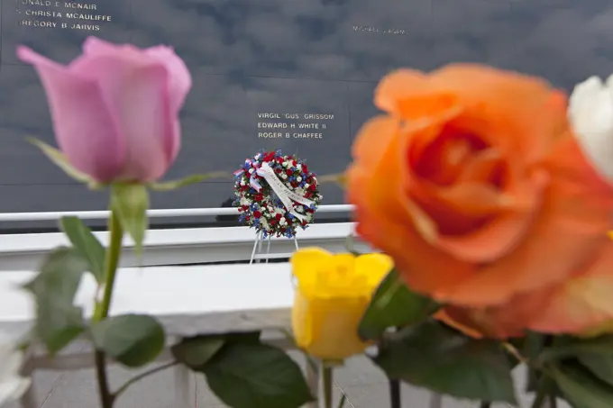 Flowers are placed near the Space Mirror Memorial at the Kennedy Space Center Visitor Complex. The names of fallen astronauts from Apollo 1, Challenger and Columbia, as well as the astronauts who perished in training and commercial airplane accidents are emblazoned on the monument. During the annual Day of Remembrance, spaceport employees and guests join others throughout NASA honoring the contributions of astronauts who have perished in the conquest of space.