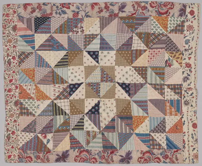 Patchwork of adjacent triangles of colorful cotton, surround with eighteenth century sits. Lining of printed cotton with flowers in red and brown on dotted soil. Lap Blanket of assigned triangles of colorful cotton, surrounded with eighteenth century sits. Lining of printed cotton with flowers in red and brown on dotted soil. Manufactured by Nelligje Kok-Bosma.