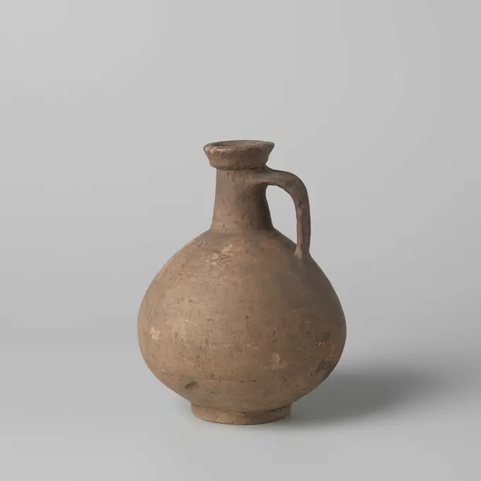 Jug. Jug of stoneware, with an ear. The jug is dirty-yellow and displayed traces of red-brown coloring.