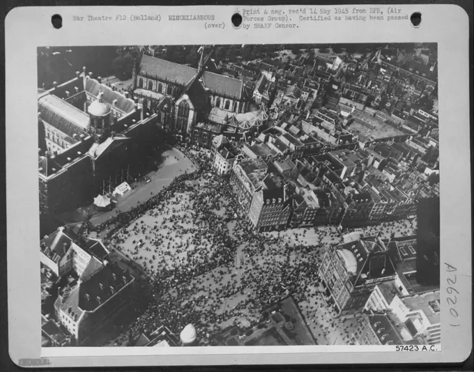 LITERATED AMSTERDAM CELEBRATES VE DAY-The people of Amsterdam, Holland throng the cathedral square to celebrate VE Day. It marks the end of five years of German oppression and they are overjoyed that the war has come to an end.