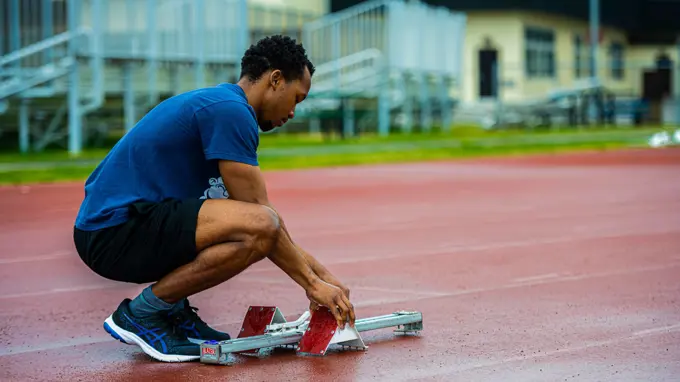 A participant from Team Misawa sets his starting blocks for a track and field event during the first-ever Sakura Olympics at Misawa Air Base, Japan, April 22, 2022. Over 40 people from around Misawa Air Base sat on the Sakura Olympics committee, organizing sports such as basketball, soccer, and powerlifting during this joint bilateral event.