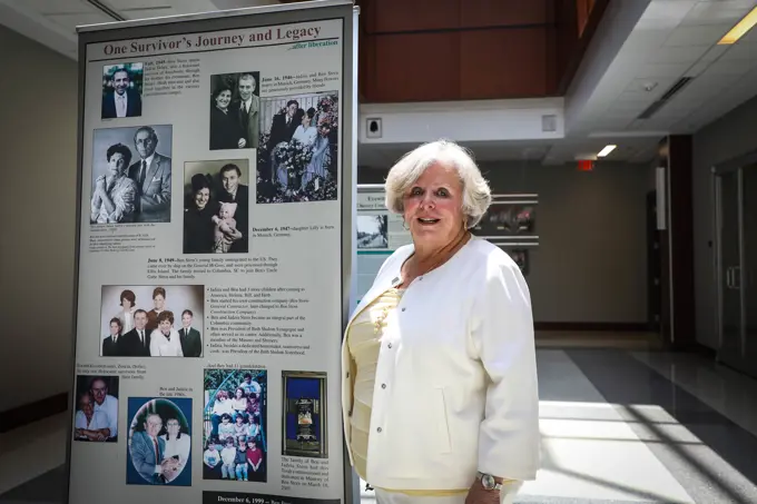 South Carolina Council on the Holocaust Chair, Dr. Lilly Filler, poses in front of a banner of her family history during U.S. Army Central's Days of Remembrance event at Patton Hall on Shaw Air Force Base, S.C., April 29, 2022. Dr. Filler's mother and father were both survivors of the Holocaust.