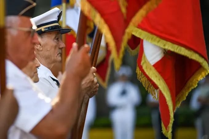 Participants display flags during a Victory in Europe Day” World War II remembrance ceremony outside the Haut-commissariat de la République Tahiti, French Polynesia, May 8, 2022. Through exercises and engagements, we improve our ability to work together with our allies and partners and build on our collective strengths.