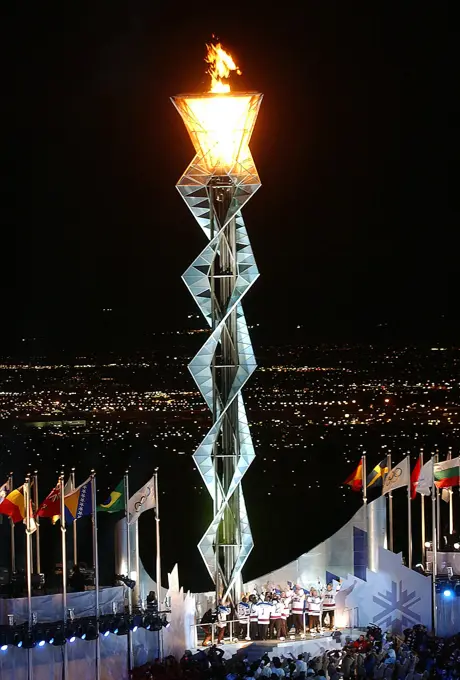 Members of the 1980 US Gold Medal Olympic hockey team stand below the Olympic flame after lighting it, at Rice-Eccles Olympic Stadium, during the opening ceremonies of the 2002 WINTER OLYMPICS in Salt Lake City. Subject Operation/Series: 2002 WINTER OLYMPICS Base: Salt Lake City State: Utah (UT) Country: United States Of America (USA)