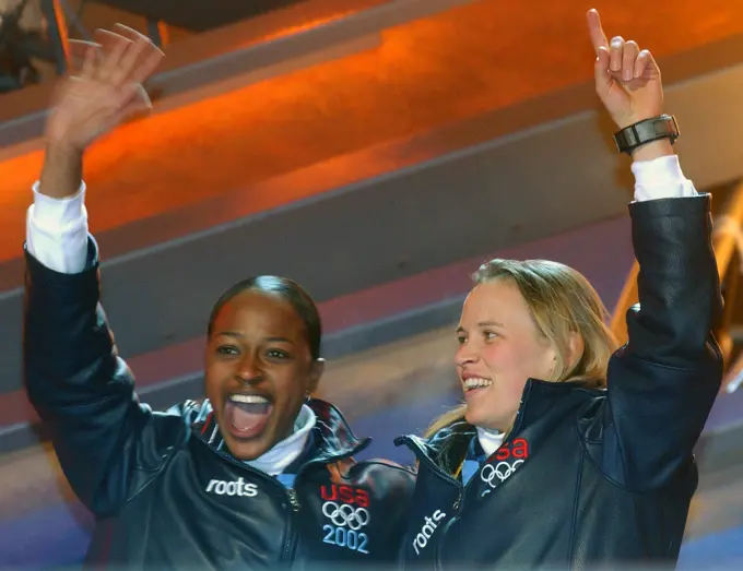 Vonetta Flowers, left, and World Class Athlete SPECIALIST Jill Bakken, USA, react to the crowd as they step up to the podium during the medal ceremony in Salt Lake City, after winning the gold medal in women's two-man bobsled for the United States in the 2002 WINTER OLYMPIC GAMES. The team was not favored going in but ended up breaking a 46 year drought for the United States, winning the Gold over another American team and favored German team, setting a track record in the process. Subject Operation/Series: 2002 WINTER OLYMPIC GAMES Base: Salt Lake City State: Utah (UT) Country: United States Of America (USA)