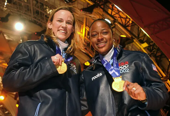 The first winners in the 2002 OLYMPIC WINTER GAMES debut for womens two-man bobsledding. World Class Athlete SPECIALIST Jill Bakken, USA, left, and Vonetta Flowers, of "USA-2" bobsled, show off their newly awarded gold medals presented to them at the medal ceremony in Salt Lake City. The team was not favored going in but ended up breaking a 46 year drought for the United States, winning the Gold over another American team and favored German team, setting a track record in the process. Subject Operation/Series: 2002 OLYMPIC WINTER GAMES Base: Salt Lake City State: Utah (UT) Country: United States Of America (USA)