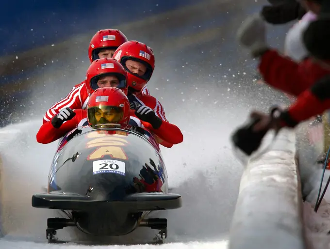 With snow and ice flying up behind them, driver Brian Shimer, World Class Athletes SPECIALIST Mike Kohn, USA, and SPECIALIST Doug Sharp, USA, and brakeman Dan Steele come to a stop. They just completed their third run for "USA-2" at the Utah Olympic Park track in Park City, Utah, during the 2002 WINTER OLYMPIC GAMES. They would surprisingly go on to win the bronze medal behind "USA-1" and "Germany-2.". Subject Operation/Series: 2002 WINTER OLYMPIC GAMES Base: Park City State: Utah (UT) Country: United States Of America (USA)