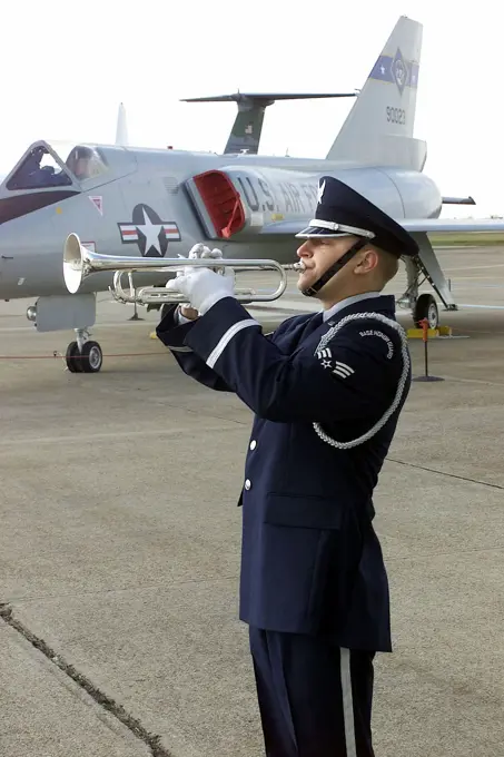 A member of the Dover Air Force Base Honor Guard plays taps during the Pearl Harbor Day Remembrance Ceremony held at the Air Mobility Command (AMC) Museum, Dover Air Force Base, Delaware. Base: Dover Air Force Base State: Delaware (DE) Country: United States Of America (USA)