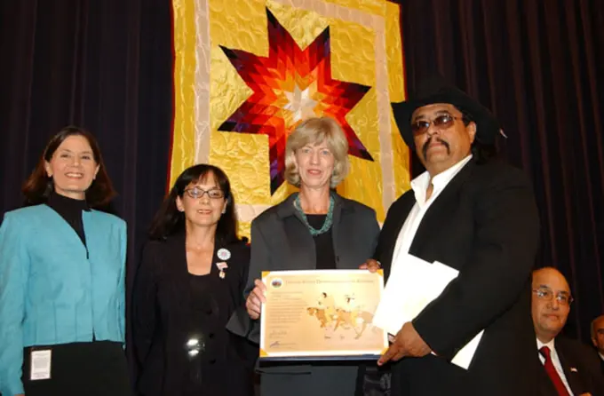 Secretary Gale Norton with Jesse Monongya, jeweler and Indian Arts and Crafts Board Commissioner, right, honoree at Living Legacy Awards event, recognizing contributions to Native American arts promotion, at Department of Interior headquarters, Washington, D.C.