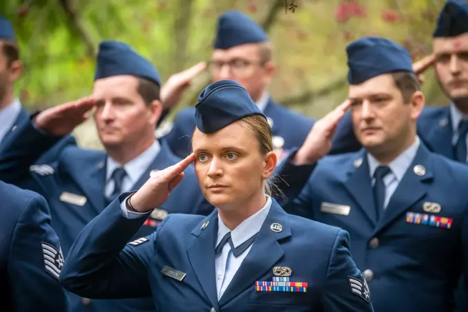 Airmen from the 420th Munitions Squadron, salute during a Remembrance Day ceremony at RAF Welford, England, Nov. 10, 2022. Airmen from the 501st Combat Support Wing, Royal Air Force, and distinguished guests came together to honor the sacrifices of armed forces veterans, past and present.