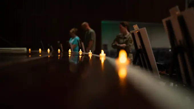 Attendees read posters about holocaust events during a candlelight ceremony in honor of the Days of Remembrance at Kadena Air Base, Japan, April 29, 2022. Historians estimate that nearly one-third of the worlds Jewish population, or six-million people, died as a result of the Holocaust.