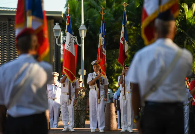 Participants hold flags in preparation for Victory in Europe Day a World War II remembrance ceremony outside the Haut-commissariat de la République Tahiti, French Polynesia, May 8, 2022. The ceremony kicks off Marara 22, a multinational training exercise which enhances combined interoperability between the U.S. military and Frances Combined Joint Task Force Headquarters in French Polynesia.