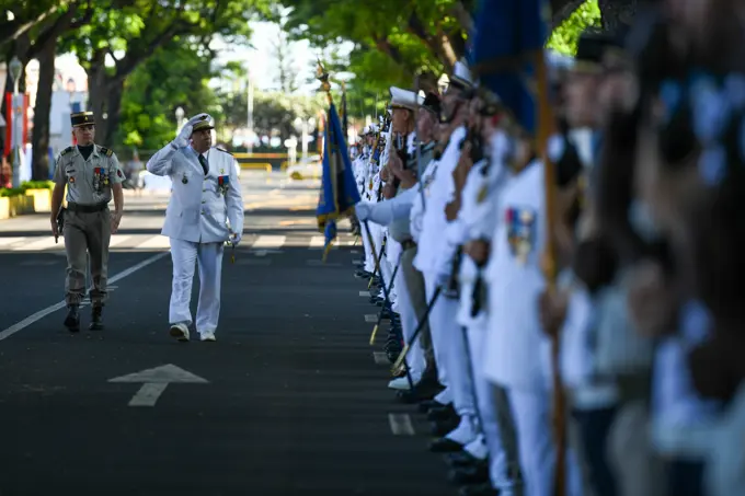 A Victory in Europe Day participant marches and salutes a multilateral formation during a World War II remembrance ceremony outside the Haut-commissariat de la République Tahiti, French Polynesia, May 8, 2022. Exercise Marara 22 will enable USINDOPACOM components to address strategic, readiness, and security cooperation measures by improving mil-to-mil relationships, increasing combined interoperability readiness, and identifying information sharing friction points or gaps, and enhancing HADR response capability development.