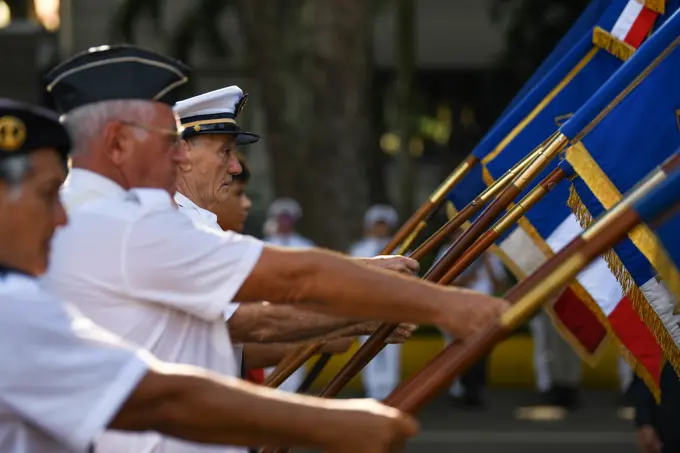 Participants display flags during a Victory in Europe Day World War II remembrance ceremony outside the Haut-commissariat de la République Tahiti, French Polynesia, May 8, 2022. Through exercises and engagements, we improve our ability to work together with our allies and partners and build on our collective strengths.