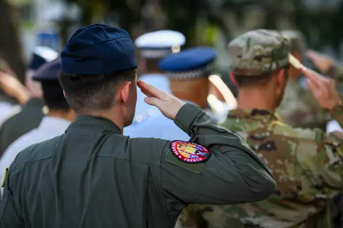 A U.S. Airmen salute as part of a multilateral formation during a Victory in Europe Day World War II remembrance ceremony outside the Haut-commissariat de la République Tahiti, French Polynesia, May 8, 2022. The ceremony kicks off Marara 22, a multinational training that advances partners abilities to address complex and future contingencies throughout the Indo-Pacific.