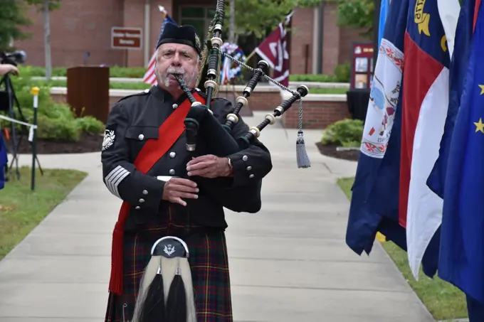 A bagpiper pipes the hymn "Amazing Grace" during the final moments of the Fort Bragg Soldier Recovery Unit Remembrance Ceremony in the shadow of Memorial Day.