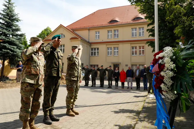 U.S. and Polish service members salute a wreath during a Memorial Day ceremony at Poznan, Poland, May 30, 2022. Memorial Day is a day of remembrance, dedicated to all those who gave their lives in service of the U.S.