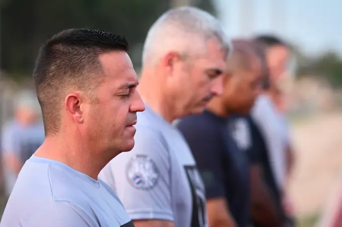 Chief Master Sgt. Justin Stoltzfus (left), 39th Air Base Wing command chief, prays during a POW/MIA remembrance ceremony at Incirlik AB, Turkey, Sept. 16, 2022. Service members and civilians gathered for a 24-hour run in honor of National POW/MIA Recognition Day. Attendees continued to run until the end of the event to remember and honor those Americans who were prisoners of war and those who served and never returned home.