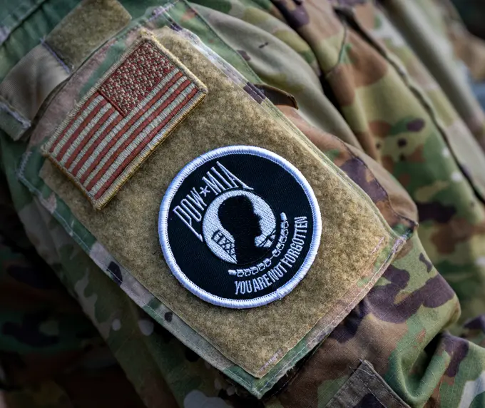 A prisoner of war and missing in action (POW/MIA) patch is affixed on the arm of Master Sgt. Andres Munoz, 51st Operations Squadron chief controller, during a remembrance ceremony at Osan Air Base, Republic of Korea, Sept. 26, 2022. Every year, National POW/MIA Recognition Day is observed on the third Friday in September to honor those who were prisoners of war or are still missing in action.